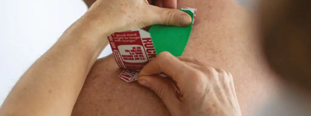 Sports Massage Exeter Julie Duff appying rock taping for sports